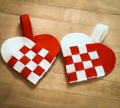 two red and white heart shaped pieces on a wooden table with one cut out to look like a checkerboard pattern