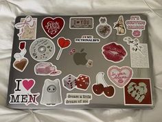 a laptop with many stickers on it