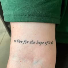 a person with a tattoo on their arm that says to live for the hope of it all