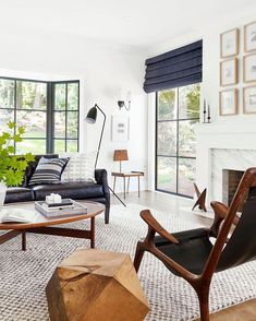 a living room filled with furniture and windows