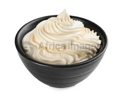 whipped cream in a black bowl on a white background