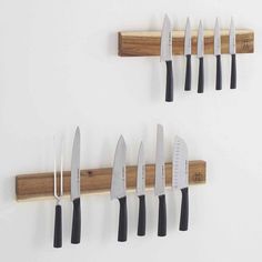 several knives are hanging on the wall