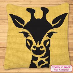 a black and yellow pillow with a giraffe's head in the middle