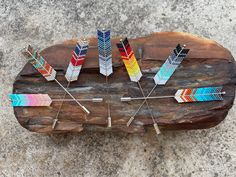 a wooden table topped with different colored pins