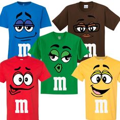 four t - shirts with m and m faces drawn on them, all in different colors