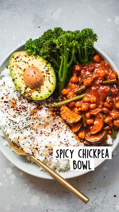 a white plate topped with rice, broccoli and beans next to an avocado