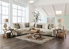 a living room filled with lots of furniture on top of a hard wood floored floor