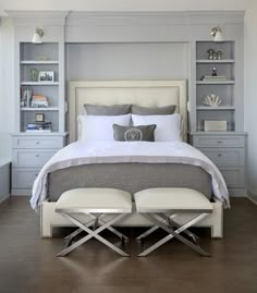 a white bed sitting in a bedroom on top of a hard wood floor