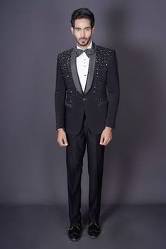 Black tuxedo blazer featuring intricate hand embroidery in scattered beaded, stones and cutdana work. Comes with a white shirt, pant and a bow-tie. - Aza Fashions Embellished Tailored Suits For Evening, Tailored Evening Suit With Sequins, Evening Tailored Embellished Suits, Tailored Embellished Tuxedo For Evening, Evening Tuxedo With Embellished Tailored Fit, Tailored Embellished Evening Suits, Evening Embellished Tailored Suits, Embellished Fitted Suits For Gala, Fitted Embellished Suits For Gala