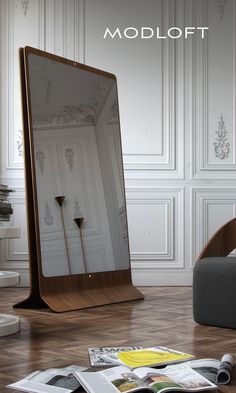 a large mirror sitting on top of a wooden floor