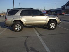 a silver suv parked in a parking lot