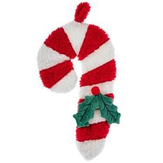 a red and white candy cane ornament with holly leaves on it's side