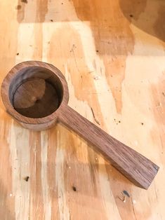 a wooden spoon sitting on top of a wooden table