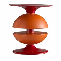 an orange and red vase sitting on top of a table