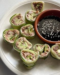 an assortment of food items on a plate with dipping sauce