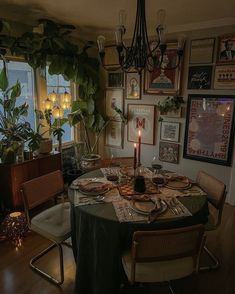 a dining room table is set with plates and place settings