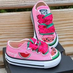 a pair of pink shoes with watermelon on them