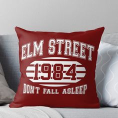 a throw pillow that says elm street, don't fall asleep