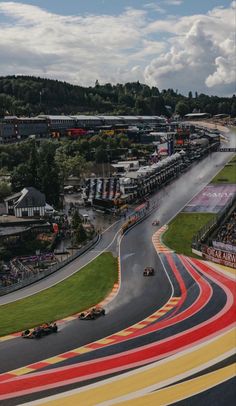 an aerial view of a race track with cars on it