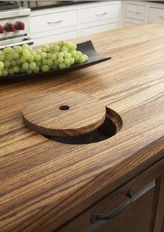 a wooden counter top with grapes on it