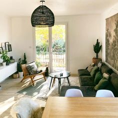 a living room filled with furniture and a wooden table in front of a sliding glass door