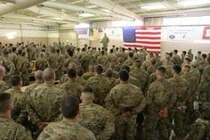 many soldiers are standing in a large room