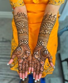 a woman's hands with hennap on her hand and the top half of her arm