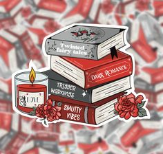 a stack of books with a candle and roses on top, surrounded by red candy wrappers