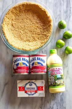 ingredients needed to make an apple pie on a marble countertop with limes and sugar