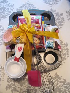 an assortment of food and utensils on a tray with a yellow ribbon tied around it