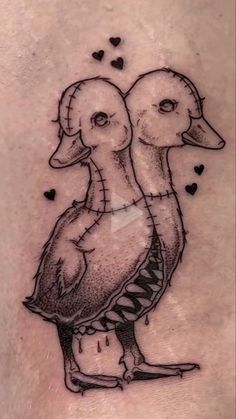 a couple of ducks sitting on top of a woman's stomach with hearts in the background