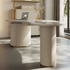 an office desk with a laptop on it in front of a window and bookshelf