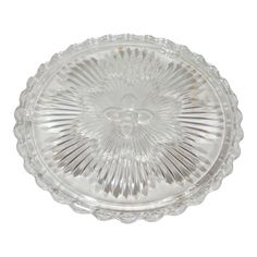 a clear glass dish with an ornate design