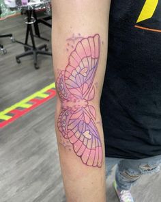 a tattoo on the arm of a person with a pink and purple butterfly on it