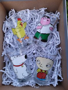 four glasses with cartoon characters on them in a box