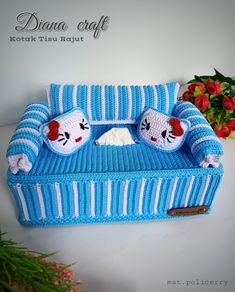 a crocheted couch with two stuffed animals on it