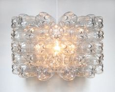 a glass light fixture mounted on the wall