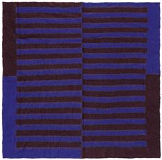 a blue and brown striped rug on a white background