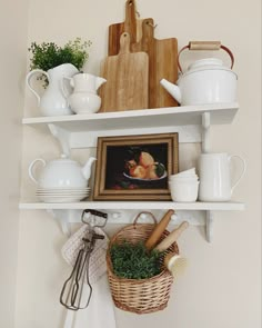 some white shelves with dishes and utensils on them