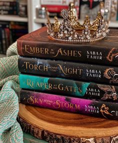 a stack of books sitting on top of a wooden table