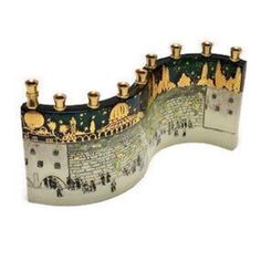 a decorative figurine of a castle with people walking on the street below it