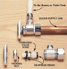 the parts of a water valve on a wooden surface