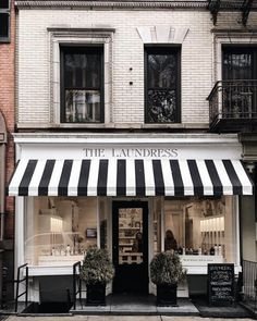 a store front with black and white striped awning