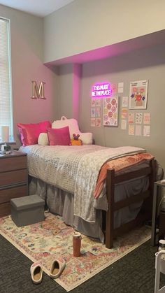 a bed room with a neatly made bed next to a window and a rug on the floor