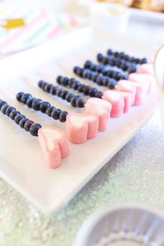 several marshmallows are arranged in the shape of hearts on a white plate