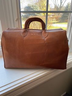 "Vintage Brown Leather Doctors Bag, House Calls Bag, Physician Bag, Monogrammed In beautiful vintage condition  There is no major damage to this bag Zipper works well  Approximately 15\" long and 9 1/2\" tall Monogrammed with the initials W.A.T." Vintage Leather Travel Bag For Formal Use, Formal Engraved Rectangular Bag, Engraved Rectangular Formal Bag, Formal Rectangular Engraved Bag, Vintage Travel Bag For Business With Leather Lining, Vintage Everyday Travel Bag With Leather Handles, Vintage Rectangular Travel Bag For Everyday, Classic Large Shoulder Bag For Travel, Classic Large Travel Shoulder Bag