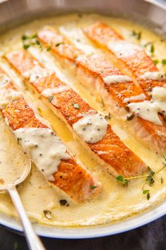 a pan filled with salmon covered in gravy