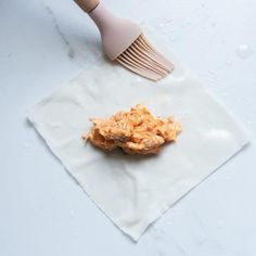 a fork on top of a napkin with some food in front of it and an egg dish next to it