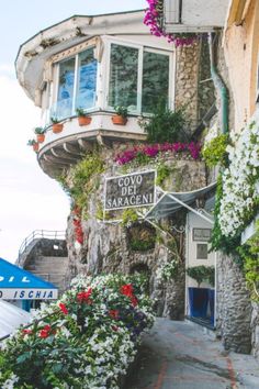 an old building with flowers growing on it