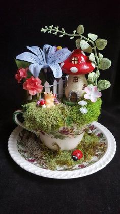 a teacup with flowers and mushrooms on it